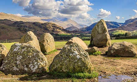 Close up view of the ancient stones with the Lake District fells in the background.